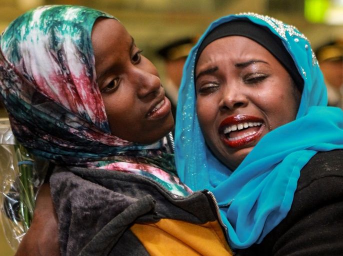 A family member sheds tears of joy as she greets Dahaba Matan (L), a refugee from Somalia, at the airport in Boise, Idaho, U.S. March 10, 2017. REUTERS/Brian Losness