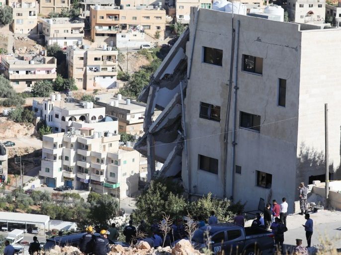 Jordan Security Forces inspect the rumble of a building after collapse during a police operation in Salt, about 30 kms from Amman, Jordan, 12 August 2018.