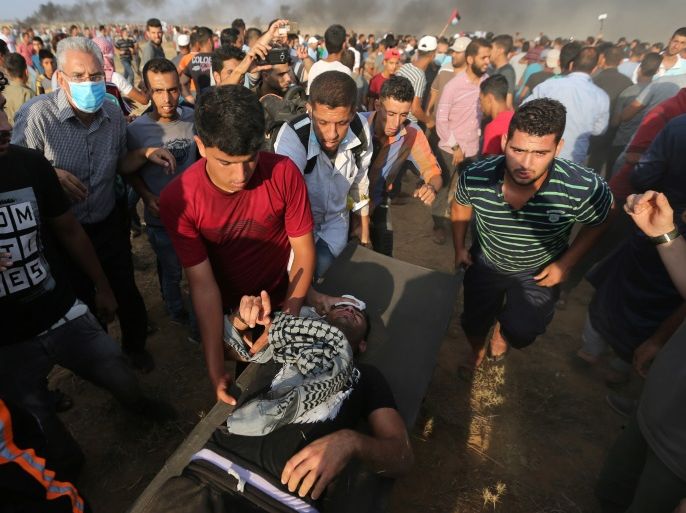 A wounded man is evacuated during a protest where Palestinians demand the right to return to their homeland at the Israel-Gaza border, in the southern Gaza Strip August 3, 2018. REUTERS/Ibraheem Abu Mustafa