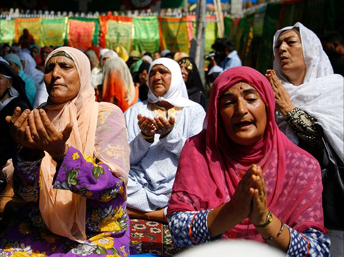 epa06955834 Kashmiri Muslim women pray outside mosque adjacent to the shrine of Shah-e-Hamdan in Srinagar, the summer capital of Indian Kashmir, 18 August 2018. Hundreds of devotees gathered at the shrine to commemorate the anniversary of the death of a famous Sufi Saint, Mir Syed Ali Hamadani. The shrine of Shah-e-Hamdan or Khanqah-e-Moulla is one of the oldest Muslim shrines in the region, commemorating the Iranian who visited Kashmir various times in the 14th century playing an influential role in the spread of Islam in Kashmir. EPA-EFE/FAROOQ KHAN