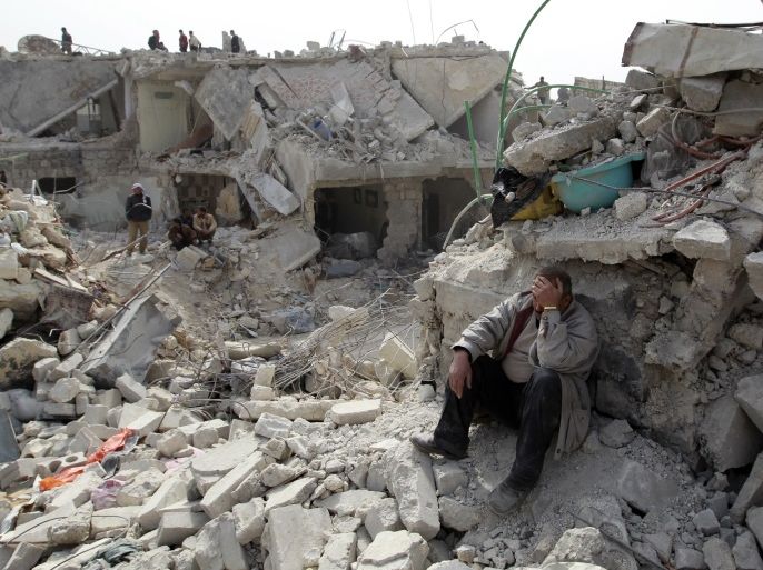 A man reacts as he sits in rubble at a site hit on Friday by what activists said was a Scud missile in Aleppo's Ard al-Hamra neighbourhood, February 23, 2013. Rockets struck eastern districts of Aleppo, Syria's biggest city, on Friday, killing at least 29 people and trapping a family of 10 in the ruins of their home, activists in the city said. REUTERS/Muzaffar Salman (SYRIA - Tags: POLITICS CIVIL UNREST)