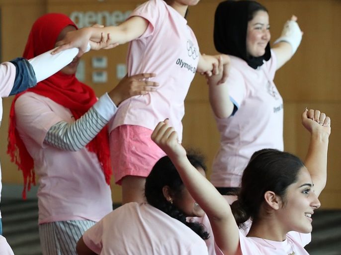 AUCKLAND, NEW ZEALAND - JUNE 19: Students have a go at cheerleading during the Olympic Refugee Sport Day at The Trusts Arena on June 19, 2018 in Auckland, New Zealand. The event saw refugees aged between 11 and 18 given the opportunity to get involved in sport and meet some of New Zealand's Olympic athletes at a 'have a go sports day. The day aims to aid the refugees integration into New Zealand society, with research showing sport and recreation has a significant and positive impact on refugees' well-being and development, especially among those who have recently arrived in a new country. (Photo by Fiona Goodall/Getty Images)