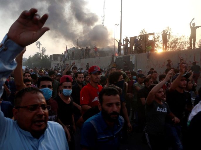 Iraqi protesters shout slogans during an anti-government protest near the burnt building of the government office in Basra, Iraq September 7, 2018. REUTERS/Alaa al-Marjani