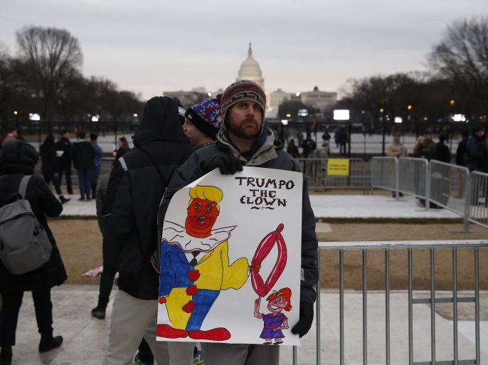 A protester gathers on the National Mall prior to U.S. President-elect Donald Trump's inauguration as the nation's 45th president in Washington, U.S., January 20, 2017. REUTERS/Shannon Stapleton