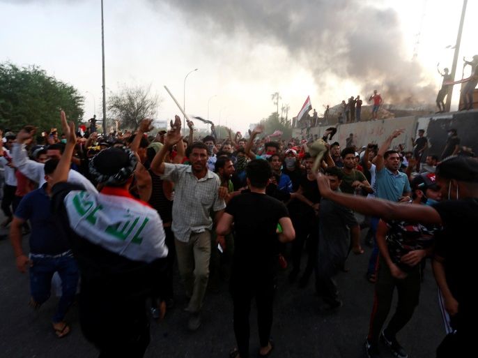 Iraqi protesters shout slogans during an anti-government protest near the burnt building of the government office in Basra, Iraq September 7, 2018. REUTERS/Alaa al-Marjani