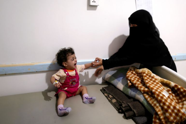 A girl cries as her mother holds her hand at a cholera treatment center in Sanaa, Yemen August 4, 2018. REUTERS/Khaled Abdullah