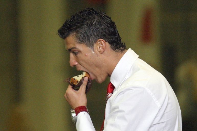 Football - Manchester City v Manchester United Barclays Premier League - The City of Manchester Stadium - 30/11/08 Manchester United's Cristiano Ronaldo eats a cake after the match Mandatory Credit: Action Images / Carl Recine Livepic NO ONLINE/INTERNET USE WITHOUT A LICENCE FROM THE FOOTBALL DATA CO LTD. FOR LICENCE ENQUIRIES PLEASE TELEPHONE +44 (0) 207 864 9000.