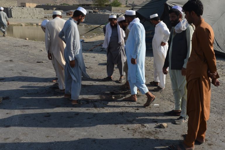 Suicide blast in Afghanistan- - NANGARHAR, AFGHANISTAN - SEPTEMBER 11: People inspect the site after a suicide blast ripped through a crowd of protesters in Nanganhar province of Afghanistan on September 11, 2018. At least 32 people were killed and 128 others wounded on the blast.