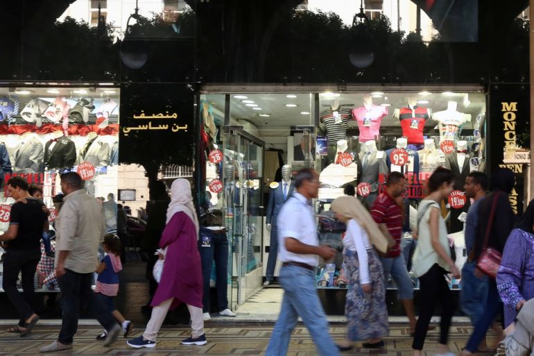 People walk past a clothes shop in Tunis, Tunisia, September 21, 2017 REUTERS/Zoubeir Souissi