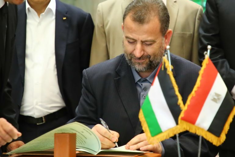 Reconciliation talks between Hamas and Fatah organizations- - CAIRO, EGYPT - OCTOBER 12 : Deputy Chairman of the Movement's Political Bureau Saleh Al-Arouri signs the reconciliation agreement to build a consensus with Palestinian Fatah movement leader Azzam Al-Ahmad (not seen) in Cairo, Egypt on October 12, 2017.