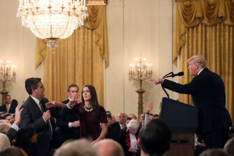 A White House staff member reaches for the microphone held by CNN's Jim Acosta as he questions U.S. President Donald Trump during a news conference following Tuesday's midterm U.S. congressional elections at the White House in Washington, U.S., November 7, 2018. REUTERS/Jonathan Ernst TPX IMAGES OF THE DAY