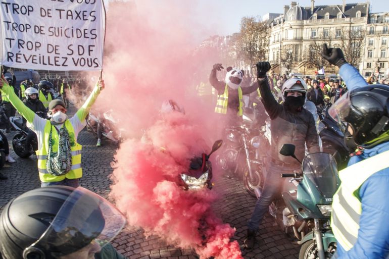 epa07173147 Bikers wearing yellow vests, as a symbol of French driver's and citizen's protest against higher fuel prices, during a demonstration on the Champs Elysee as part of a nationwide protest in Paris, France, 17 November 2018. The so-called 'gilets jaunes' (yellow vests) protest movement, which has reportedly no political affiliation, is protesting over fuel prices. According to reports, a female protester died after she was ran over by a vehicle in the south