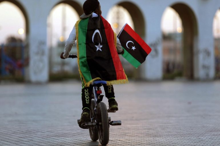 A boy wearing a Libyan flag takes part in a celebration marking the sixth anniversary of the Libyan revolution, in Benghazi, Libya February 17, 2017. REUTERS/Esam Omran Al-Fetori TPX IMAGES OF THE DAY