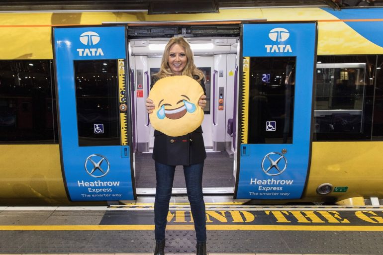 LONDON, ENGLAND - JANUARY 16: Carol Vorderman poses for a photo with a happy emoji to help cheer passengers on 'Blue Monday' and to highlight the Heathrow Express Service from Paddington Station on January 16, 2017 at Paddington Station in London, England. Today is known as 'Blue Monday', reported as the most depressing day of the year and so Heathrow Express will be on hand to offer free travel during certain hours of the day. (Photo by Tim P. Whitby/Getty Image