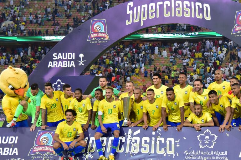 Soccer Football - International Friendly - Brazil v Argentina - King Abdullah Sports City, Jeddah, Saudi Arabia - October 16, 2018 Brazil players pose for a photo with the trophy as they celebrate after the match REUTERS/Waleed Ali