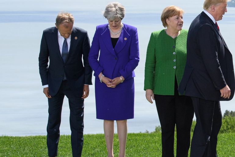 LA MALBAIE , QC - JUNE 08: President of the European Council Donald Tusk (L), Britain's Prime Minister Theresa May (2L), Germany's Chancellor Angela Merkel (2R) and President of the United States of America Donald Trump (R) prepare themselves for the Family photo on the first day of the G7 Summit, on 8 June, 2018 in La Malbaie, Canada. Canada will host the leaders of the UK, Italy, the US, France, Germany and Japan for the two day summit, in the town of La Malbaie.