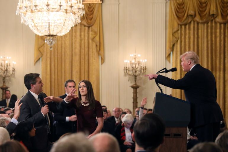 A White House staff member reaches for the microphone held by CNN's Jim Acosta as he questions U.S. President Donald Trump during a news conference following Tuesday's midterm U.S. congressional elections at the White House in Washington, U.S., November 7, 2018. REUTERS/Jonathan Ernst TPX IMAGES OF THE DAY