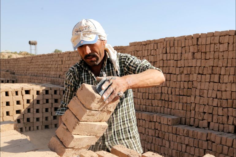 epa05539317 An Afghan migrant, who lives in Iran, works in a brick Kiln at the Qasem abad village outside the city of Varamin, Iran, 14 September 2016. Laborers at the brick kiln work almost 14 hours for 10 dollars daily wage, as they are only able to do the job six month of year when the weather is hot. In the winter they go back to their home in the city of Khvaf, Khorasan province. EPA/ABEDIN TAHERKENAREH