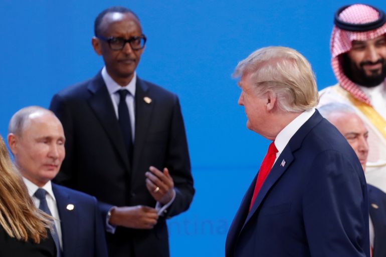 U.S. President Donald Trump walks past Russia's President Vladimir Putin, Rwandan President and African Union chairperson Paul Kagame, Saudi Crown Prince Mohammed bin Salman and Brazil's President Michel Temer as he arrives for a family photo during the G20 leaders summit in Buenos Aires, Argentina November 30, 2018. REUTERS/Kevin Lamarque