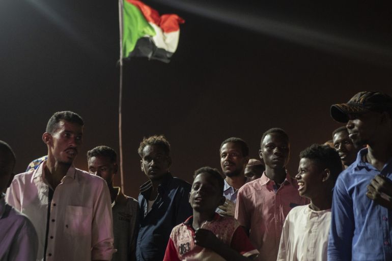 KHARTOUM, SUDAN - APRIL 27: Protestors stand in the street outside the Ministry of Defence during evening protests against the military junta on April 27, 2019 in Khartoum, Sudan. After months of protesting from the people of Sudan, organised by the Sudanese Professionals' Association (SPA), President Omar al-Bashir was ousted having been in power since 1989. The following day they also forced his successor, Awad Ibn Auf, to step down. The SPA and the people have organised a sit in at the Ministry of Defence calling for the
