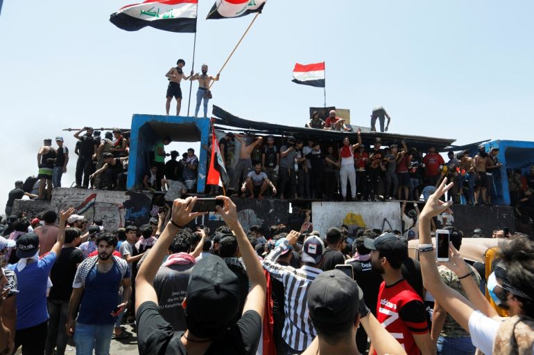 Demonstrators gesture as they take part in the ongoing anti-government protests after newly-appointed Iraqi Prime Minister Mustafa al-Kadhimi called for the release of all detained protesters, at Jumhuriya bridge in Baghdad, Iraq May 10, 2020. REUTERS/Khalid al-Mousily