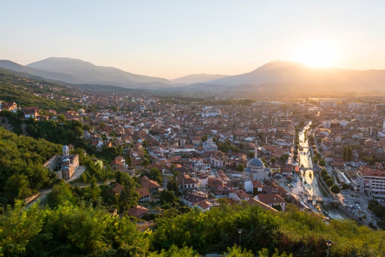 Sunset over the historic city of Prizren, Kosovo. The river is the Prizrenska Bistrica, and a mosque and church are both visible on the left side of the river. GettyImages-586702164