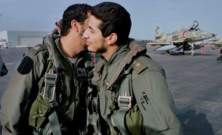 Two Kuwaiti Air Force fighter pilots greet each other on the tarmac after landing at the coalition airbase in Dhahran, Saudi Arabia in January of 1991. The two pilots had just completed a bombing mission on Iraqi army targets just outside of Kuwait City during The Persian Gulf War. The pilots were part of large contingent of Kuwaiti Air Force personnel who escaped their country when Iraq invaded in August of 1990. An A-4 Skyhawk fighter jet sits parked in the background. REUTERS/Andy Clark (SAUDI ARABIA - Tags: TRANSPORT CONFLICT POLITICS MILITARY)