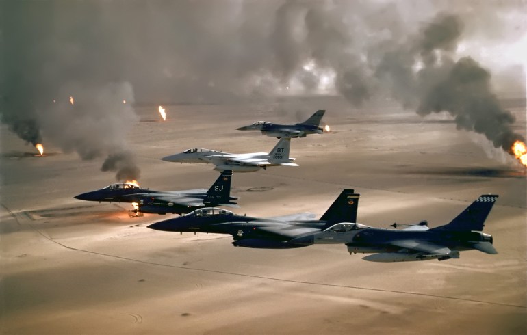 A USAF photo, showing F-16 A, F-15C and F-15E planes flying over the burning oil fields of Kuwait during Desert Storm credit : air combat comand puplic domain