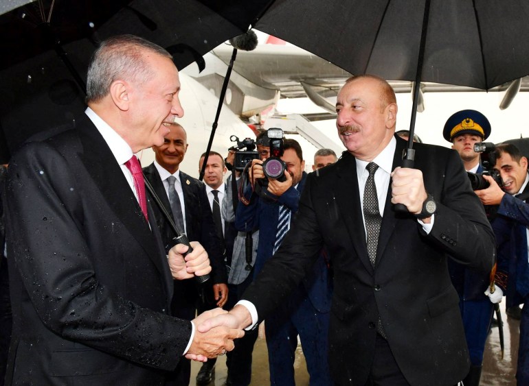 Azerbaijani President Ilham Aliyev welcomes Turkish President Tayyip Erdogan upon his arrival at Nakhchivan airport, Azerbaijan September 25, 2023. President of the Republic of Azerbaijan/Handout via REUTERS ATTENTION EDITORS - THIS IMAGE WAS PROVIDED BY A THIRD PARTY. NO RESALES. NO ARCHIVES. MANDATORY CREDIT.