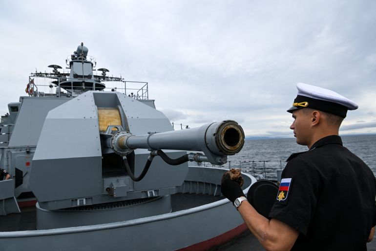 A sailor of the Marshal Shaposhnikov anti-submarine destroyer takes part in the 'Vostok-2022' military exercises at the Peter the Great Gulf of the Sea of Japan outside the city of Vladivostok on September 5, 2022. The Vostok 2022 military exercises, involving several Kremlin-friendly countries including China, takes place from September 1-7 across several training grounds in Russia's Far East and in the waters off it. Over 50,000 soldiers and more than 5,000 units of military equipment, including 140 aircraft and 60 ships, are involved in the drills. (Photo by Kirill KUDRYAVTSEV / AFP)