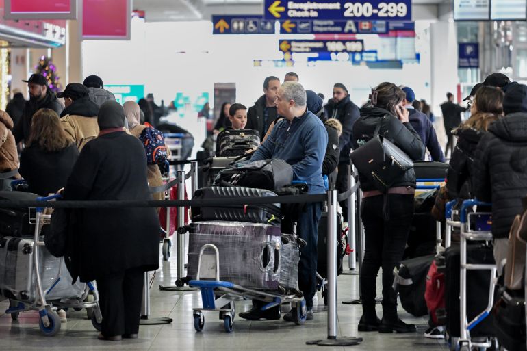 Travelers at Montreal-Pierre Elliott Trudeau International Airport (YUL) in Montreal, Quebec, Canada, on Wednesday, Dec. 20, 2023. The airport will welcome its 21 millionth passenger in the coming weeks, after a record year for traffic. Photographer: Graham Hughes/Bloomberg via Getty Images