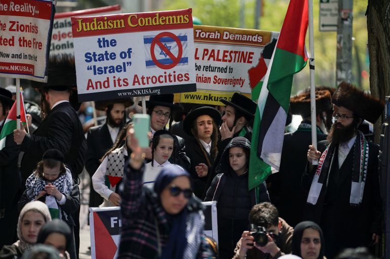 Orthodox Jews hold placards showing solidarity with Palestinians as they gather outside the Columbia University campus where a student protest encampment takes place, during the ongoing conflict between Israel and the Palestinian Islamist group Hamas, in New York City, U.S., April 26, 2024. REUTERS/David Dee Delgado