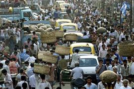 -Cars and people move through a busy street in the eastern Indian city of Calcutta on March 28, 2001. Indian officials said on Monday that the country's population totalled 1.027 billion as of March 1. According to the provisionial results of a census carried out once every decade, the country added about 181 million people between 1991 and 2001. Census officials said India's West Bengal state, of which Calcutta is the capital, has the highest population density in the country. REUTERS