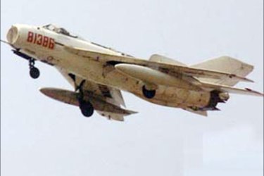 r - A Chinese military jet flies over Haikou, Hainan island April 10, 2001