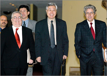 Chinese ambassador to the United Nations Wang Yingfan (C) walks to the Security Council for consultations on Iraq with Syrian ambassador Mikhail Wehbe (L) and Mexican ambassador Adolfo Aguilar Zinser (R) at the U.N. in New York on October 25, 2002. The United States stepped up its push for a vote on Iraqi disarmament in the Security Council by formally introducing its draft resolution to head of challenges from France and Russia. REUTERS/Peter Morgan