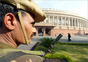 Indian security personnel stand guard near Indian parliament building in New Delhi December 13, 2002. Security around parliament was beefed-up on Friday exactly one-year after gunmen attacked the building leaving 14 people dead and heightening tensions with neighboring Pakistan. REUTERS/Kamal Kishore