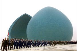 Iraqi soldiers parade in front of the Martyrs monument in Baghdad as Iraq marks Martyrs Day December 1, 2002. The monument was built during the 1980-88 Iran-Iraq war. U.N. arms experts visited an agricultural facility and a military industrial complex near Baghdad on Sunday, the fourth day of inspections in a hunt for Iraqi weapons of mass destruction. REUTERS/Akram Salah