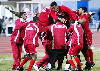 Members of Bahrain's soccer team celebrate the winning goal against Jordan during an Arab Cup semi final football match in Kuwait City December 28, 2002. Bahrain won 2-1 and qualified into the final against Saudi Arabia.REUTERS/Peter Andrews REUTERS