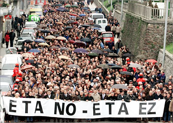 Thousands of demonstrators and politicians march in protest the day after police sergeant Joseba Pagazaurtundua was shot dead in the Basque Country town of Andoain February 9, 2003. Pagazaurtundua was killed by a hooded gunman in an attack which authorities blamed on outlawed separatist guerrilla group ETA. The banner in the front reads in Spanish and Euskera (Basque language), "ETA NO". REUTERS/Pablo Sanchez REUTERS