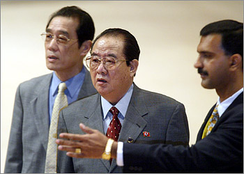 North Korean Foreign Minister Paek Nam-sun (C) is directed by an official as he arrives for the Non-Aligned Movement (NAM) summit of foreign ministers meeting in Kuala Lumpur February 22, 2003. Isolated North Korea found itself even more lonely on Friday when fellow members of the Non-Aligned Movement (NAM) rejected its call to condemn the United States and urged it to curb its nuclear ambitions. REUTERS/Zainal Abd Halim