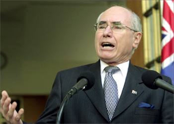 Australian Prime Minister John Howard addresses a news conference outside his Parliament House office in Canberra where he announced Australia's support for a U.S. led attack on Iraq, March 18, 2003. Australian troops will fight in a war against Iraq if the United States launches military action to disarm Baghdad of alleged weapons of mass destruction, Prime Minister John Howard said on Tuesday. EDITORIAL USE ONLY REUTERS/Canberra Times