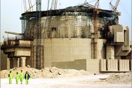 Workmen wearing protective clothing walk away from the Russian-built Bushehr nuclear power reactor under construction in southwestern Iran during an organised media visit to the plant on March 11, 2003. Officials told journalists that the plant, which Washington fears is part of a programme to build nuclear weapons, would receive its first shipment of enriched uranium from Russia in May. The 1000 MW plant is due to become operational in the second half of 2004. Iran denies any intention of building nuclear weapons but the United States on March 11 urged Iran to accept tighter inspections by the International Atomic Energy Agency. REUTERS/Morteza Nikoubazl