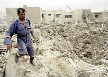 An Iraqi fireman runs over the ruins of a house destroyed by afternoon US-British coalition bombing in Baghdad's al-Mansur neighborhood 07 April 2003. Nine civilians were killed when a missile crashed into the residential quarter in central Baghdad, leaving a 10-meter deep large crater and destroying three houses off the main commercial artery of Ramadan 14th. AFP PHOTO/Karim SAHIB