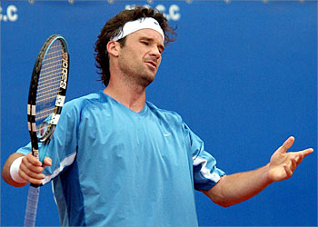 Spanish Carlos Moya shows signs of disappointment after his defeat against Argentinian Guillermo Coria during their semi-final tennis match at the Monte Carlo Masters Series, 19 April 2003 in Monaco. Coria won 7-6 (7/3), 6-2. AFP PHOTO PASCAL GUYOT