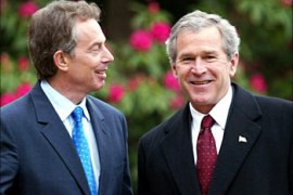 Britain's Prime Minister Tony Blair (L) looks towards U.S. President George W. Bush at Hillsborough Castle near Belfast in Northern Ireland, April 7, 2003. Iraqi war allies George W. Bush and Tony Blair will try to unravel three daunting knots - Iraq, the Israeli-Palestinian conflict and Northern Ireland -- at their third summit in three weeks at Hillsborough Castle, County Down, 15 miles south of Belfast. REUTERS/Paul Faith/POOL