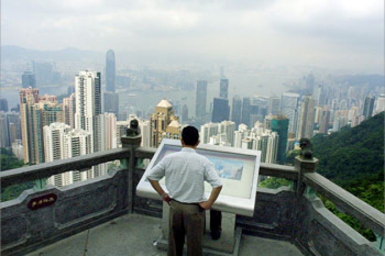 A lone mainland Chinese visitor takes a bird's eye view of Hong Kong, 24 May 2003. The World Health Organisation (WHO) lifted on 23 May its Severe Acute Respiratory Sydrome (SARS) travel warning on the territory. There were no new cases of SARS reported 24 May and two deaths attributed to the disease were recorded