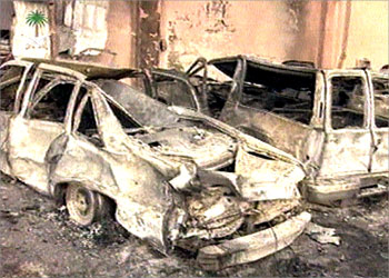 Wrecked vehicles are seen in front of damaged buildings after a suicide attack on a Westerners' compound in Riyadh, May 13, 2003. Suicide bombers injured more than 40 Americans and other nationals and probably killed others in devastating attacks on Westerners' compounds in Riyadh on Monday night, a Saudi minister and the U.S. ambassador said. SAUDI ARABIA OUT. EDITORIAL USE ONLY. NO ARCHIVE. NO SALES. REUTERS/Saudi Television