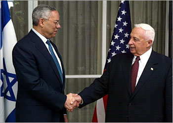 US secretary of state Colin Powell (L) shake hands with Israeli Prime Minister Ariel Sharon during the start of their meeting at Sharon's residencel in Jerusalem 11 May 2003. Powell called on Israel and the Palestinians to begin implementing the internationally-backed roadmap for peace. AFP PHOTO/MENAHEM KAHANA