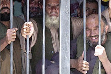 Afghan prisoners turned over to Afghan authorities after their release from the maximum security detention center at Guatanamo Bay wait in Kabul prison, 10 May 2003. Until now only 23 of the more than 660 prisoners have been released from the maximum security detention center at Guatanamo Bay. Most were captured in Afghanistan during the war that toppled its Taliban regime following terrorist attacks on New York and Washington, 11 September 2001. AFP PHOTO/SHAH Marai