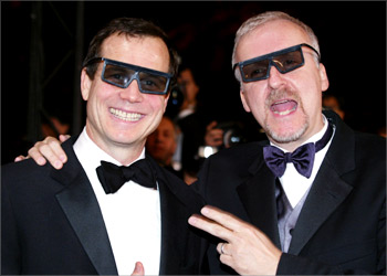 US director James Cameron (R) and actor and narrator Bill Baxton (L) wear 3-D glasses during red-carpet arrivals for their documentary film "Ghosts of the Abyss" about the Titanic at the 56th International Film Festival in Cannes, May 17, 2003. Cameron's documentary film is screened out-of-competition at the 12-day festival. REUTERS/Eric Gaillard